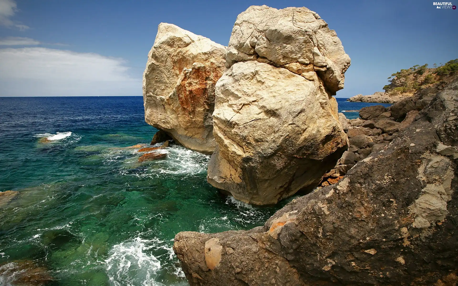 Sky, boulders, sea