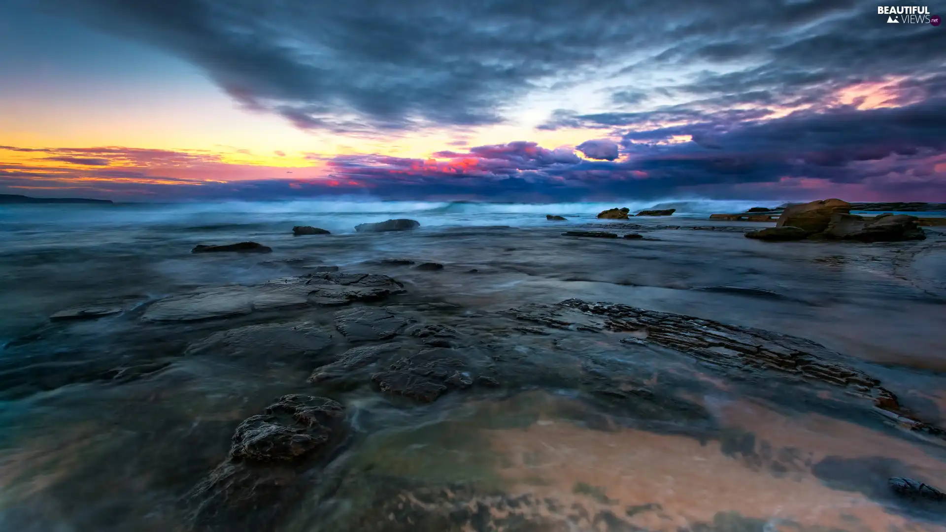 Stones, rays, sun, sea, east